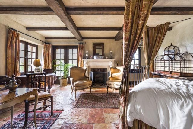 a living room with furniture large window and fireplace