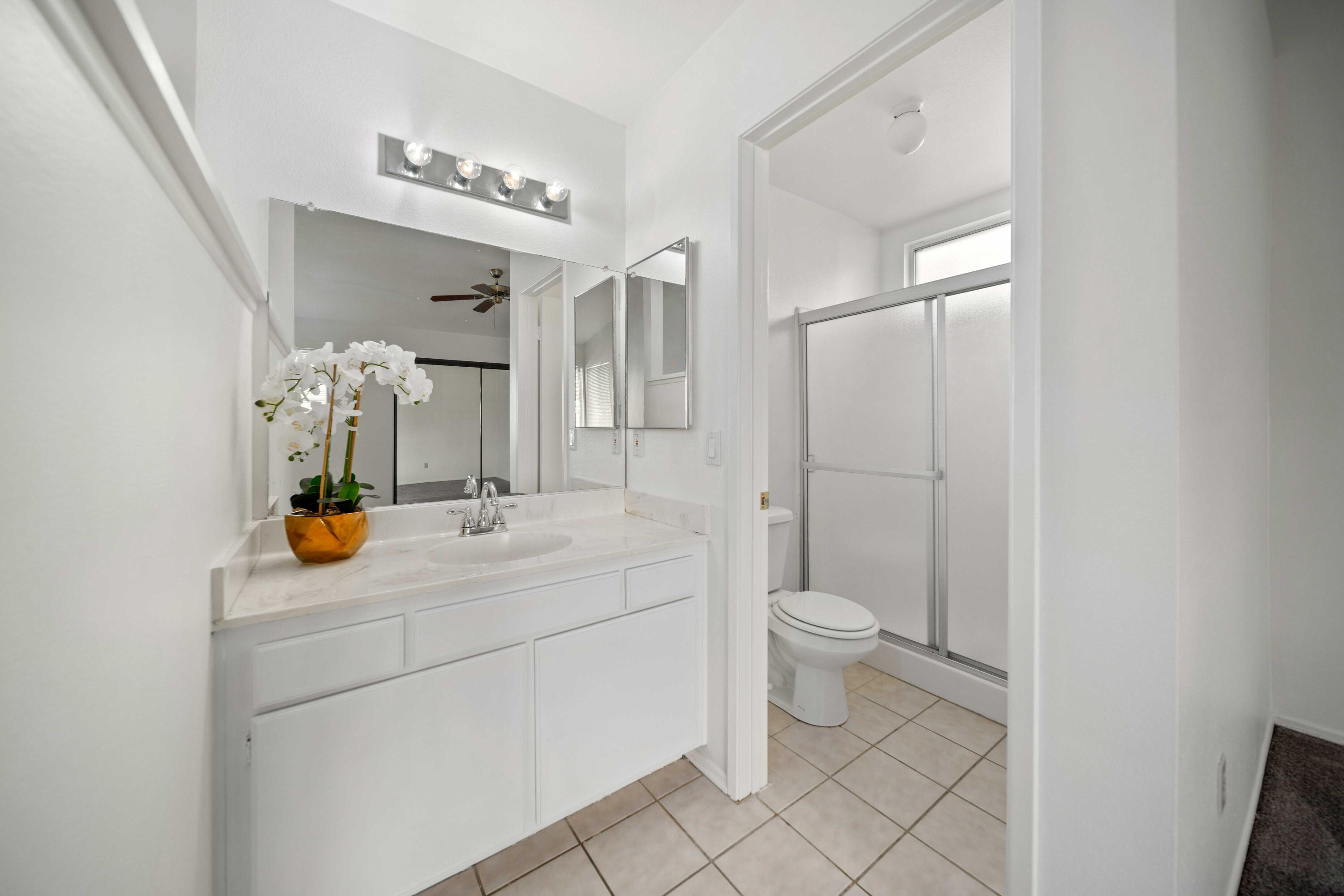 1247 Coventry Place Palmdale, CA 93551 - Photo 16 of 20 a bathroom with a toilet sink and mirror