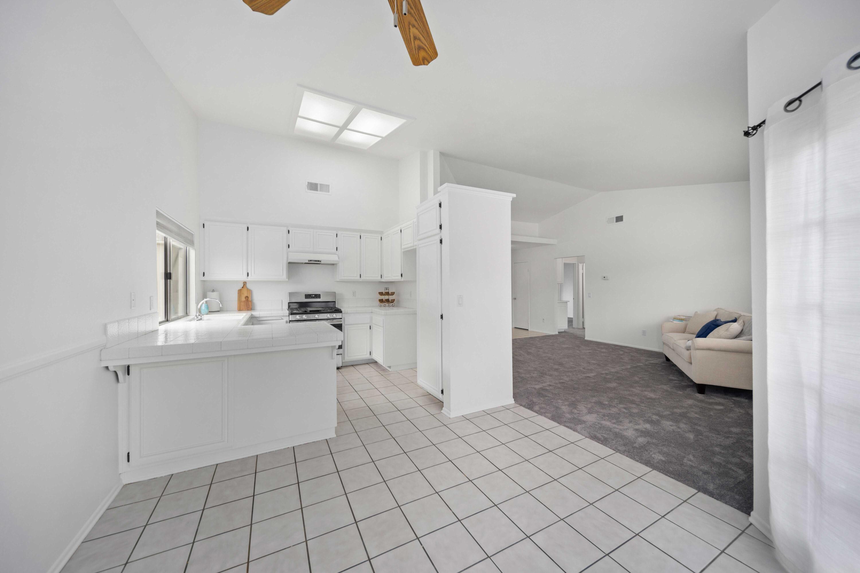 1247 Coventry Place Palmdale, CA 93551 - Photo 6 of 20 a living room with furniture and a chandelier