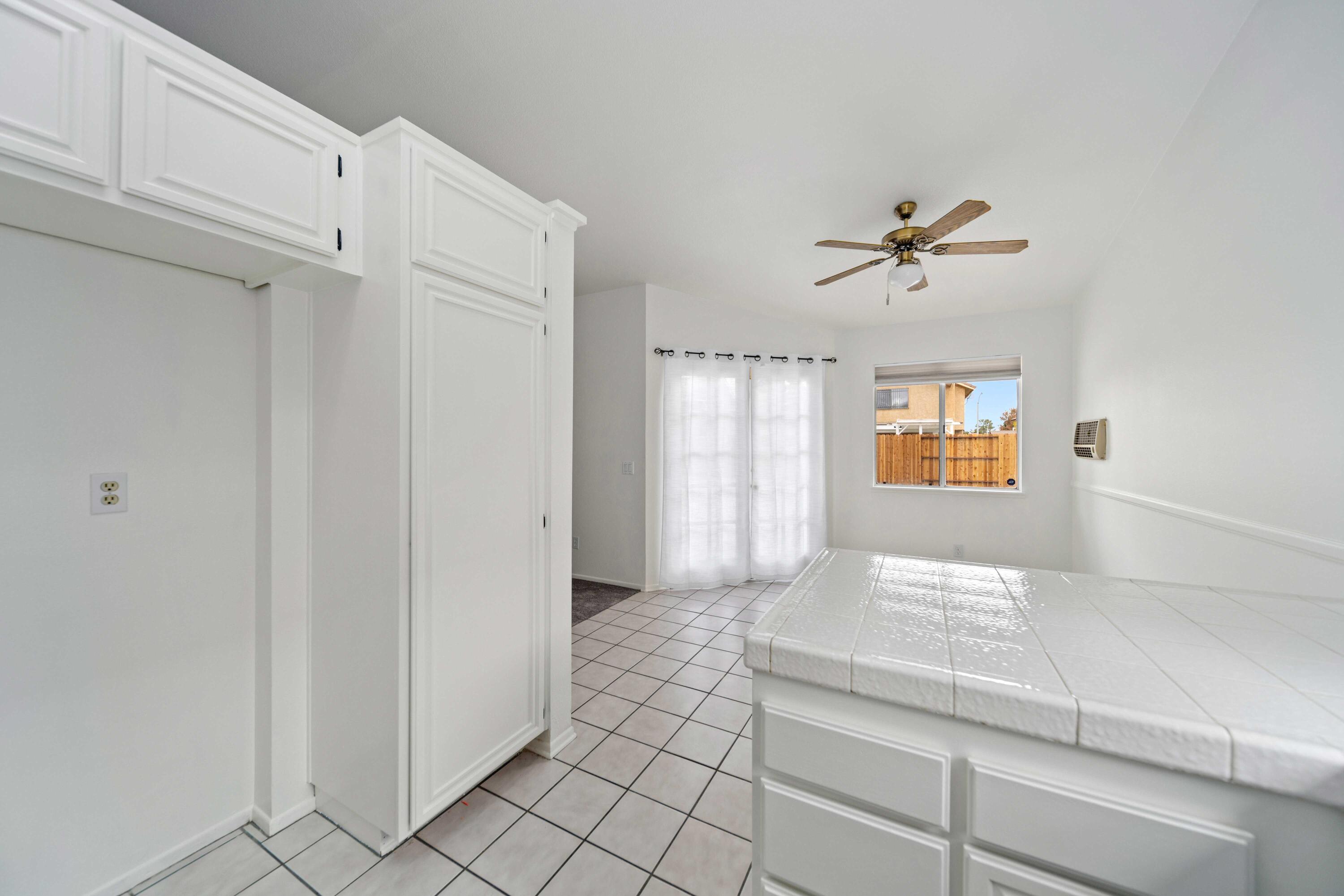 1247 Coventry Place Palmdale, CA 93551 - Photo 9 of 20 a view of bathroom with a window and a chandelier fan