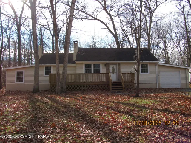 a house that has a tree in front of it