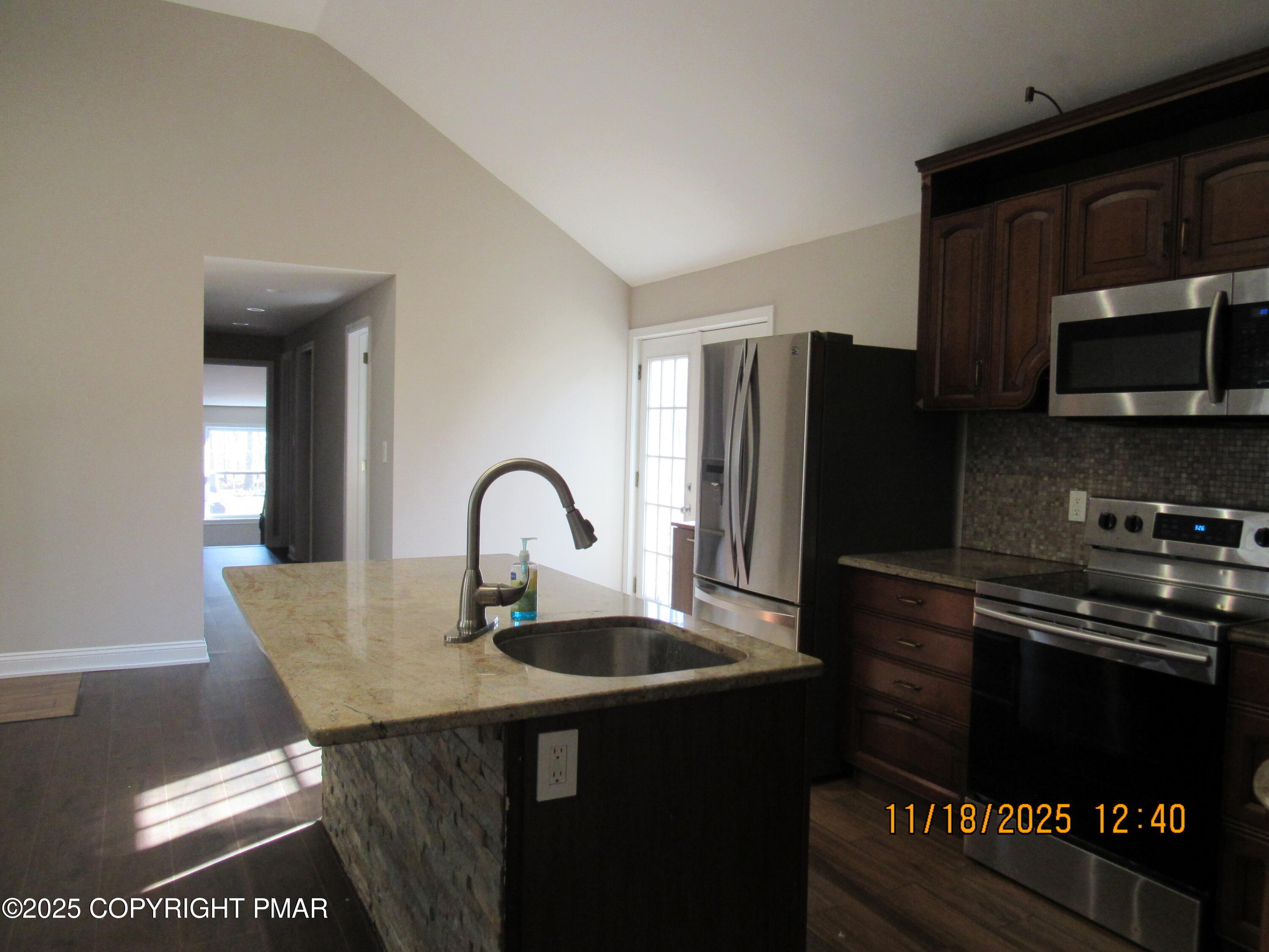 867 Underwood Road West East Stroudsburg, PA 18302 - Photo 15 of 36 a kitchen with granite countertop a refrigerator and a stove top oven