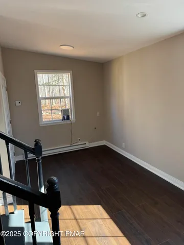 a view of entryway with wooden floor