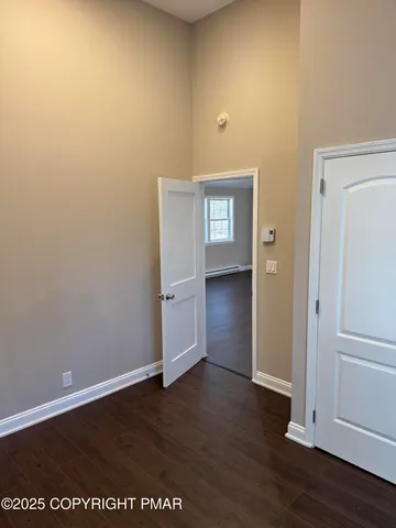 a view of an empty room and wooden floor