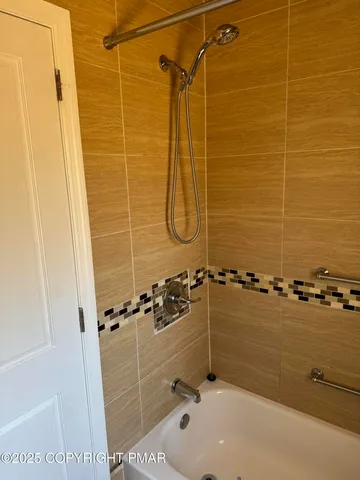 a bathroom with a shower and a bath tub