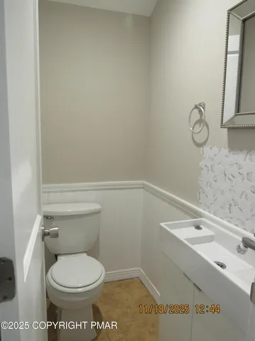 a white toilet sitting next to a bathroom sink