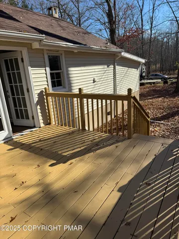 a view of a house with a wooden fence
