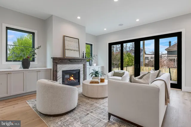 a living room with fireplace furniture and a wooden floor