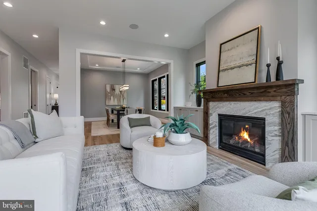 a living room with furniture and view of kitchen