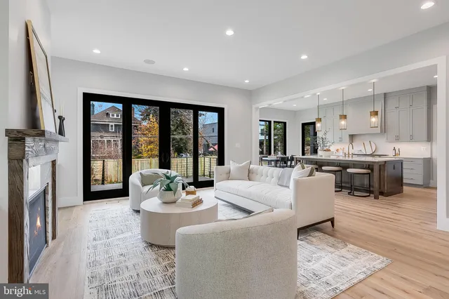 a kitchen with a sink a refrigerator and chairs