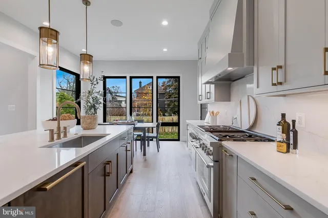 a kitchen with a sink cabinets and stainless steel appliances
