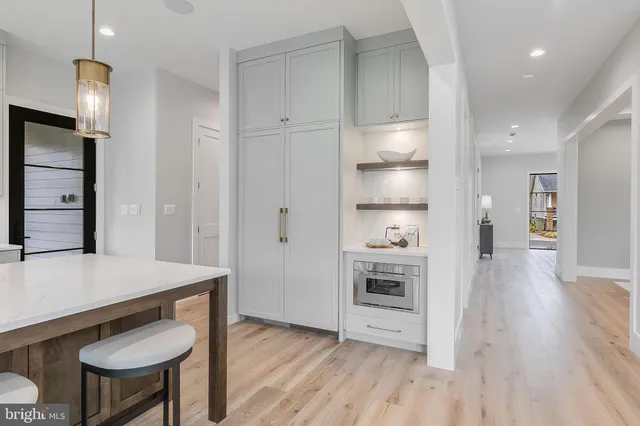 a spacious bedroom with a bed and a chandelier