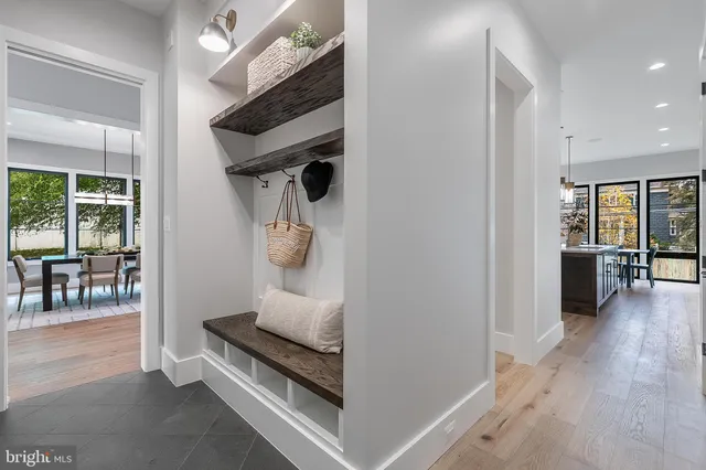 a spacious bathroom with a double vanity sink a large mirror and a bathtub