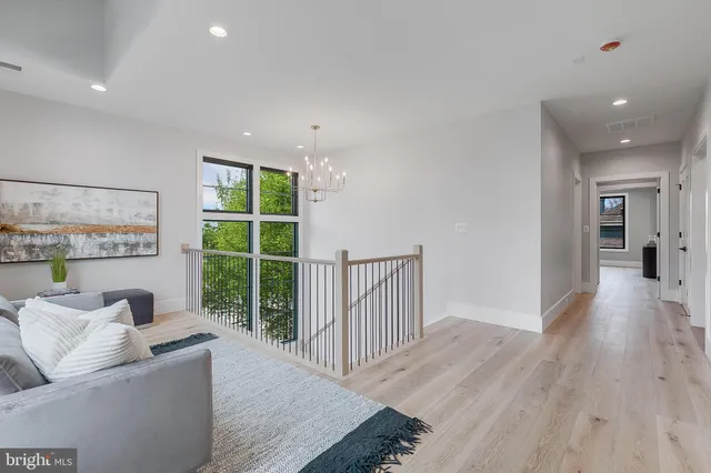 a bathroom with a toilet a sink a mirror a bathtub and vanity