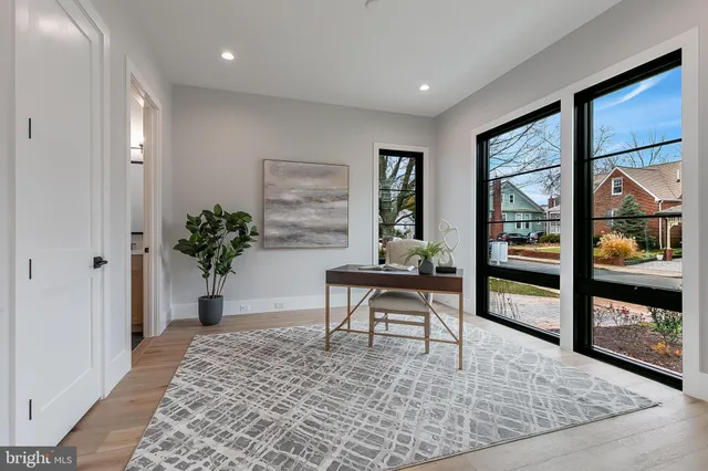 a view of a dining room and livingroom with furniture wooden floor a chandelier