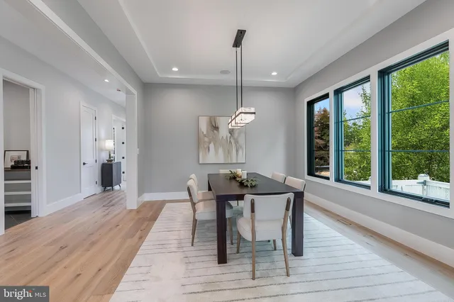 a living room with fireplace furniture and a large window