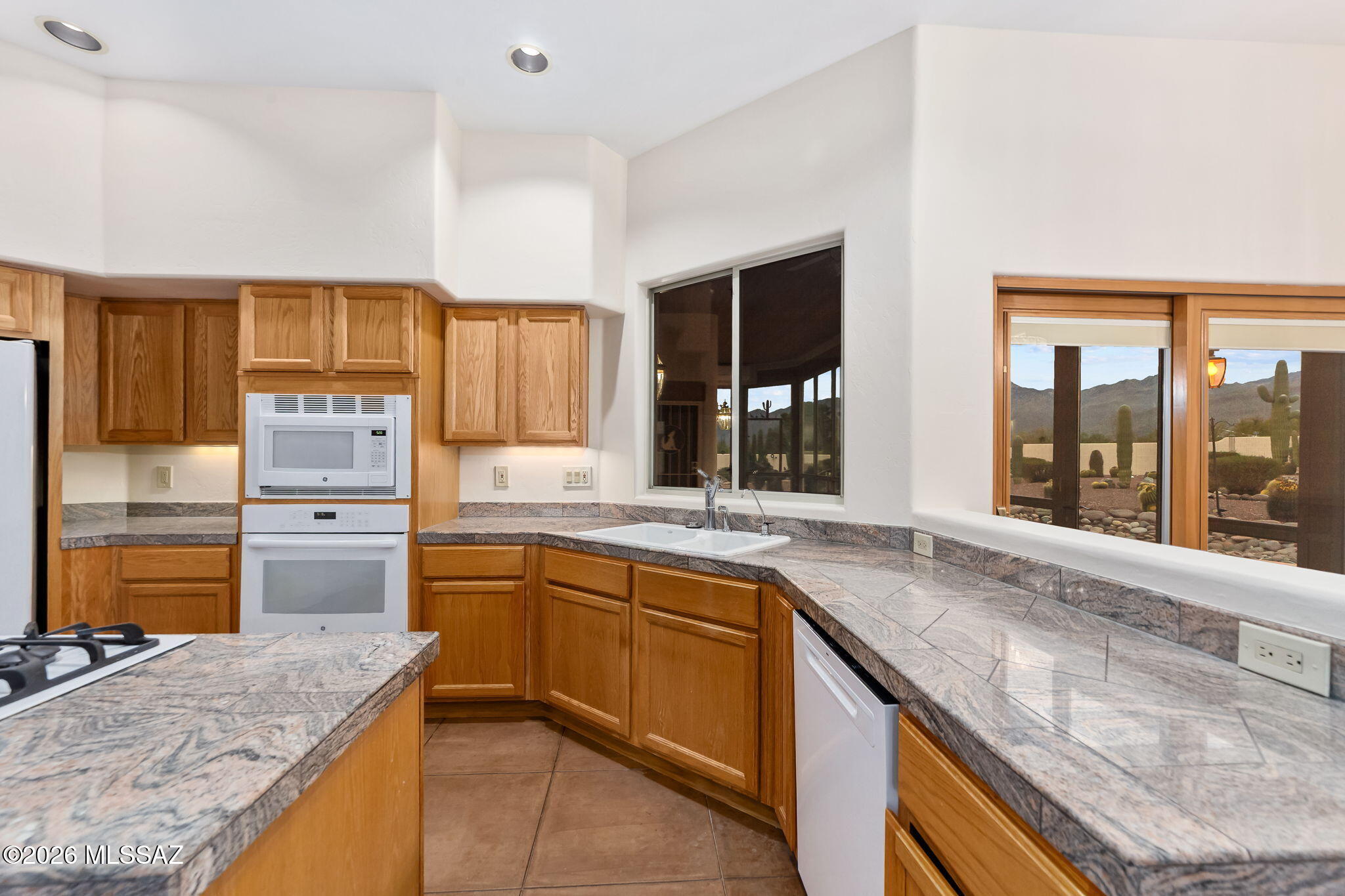 3655 North Harrison Road Tucson, AZ 85749 - Photo 17 of 51 a kitchen that has a sink and a stove in it