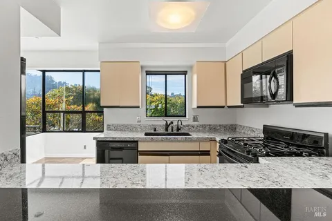 a kitchen with a refrigerator stove and a sink