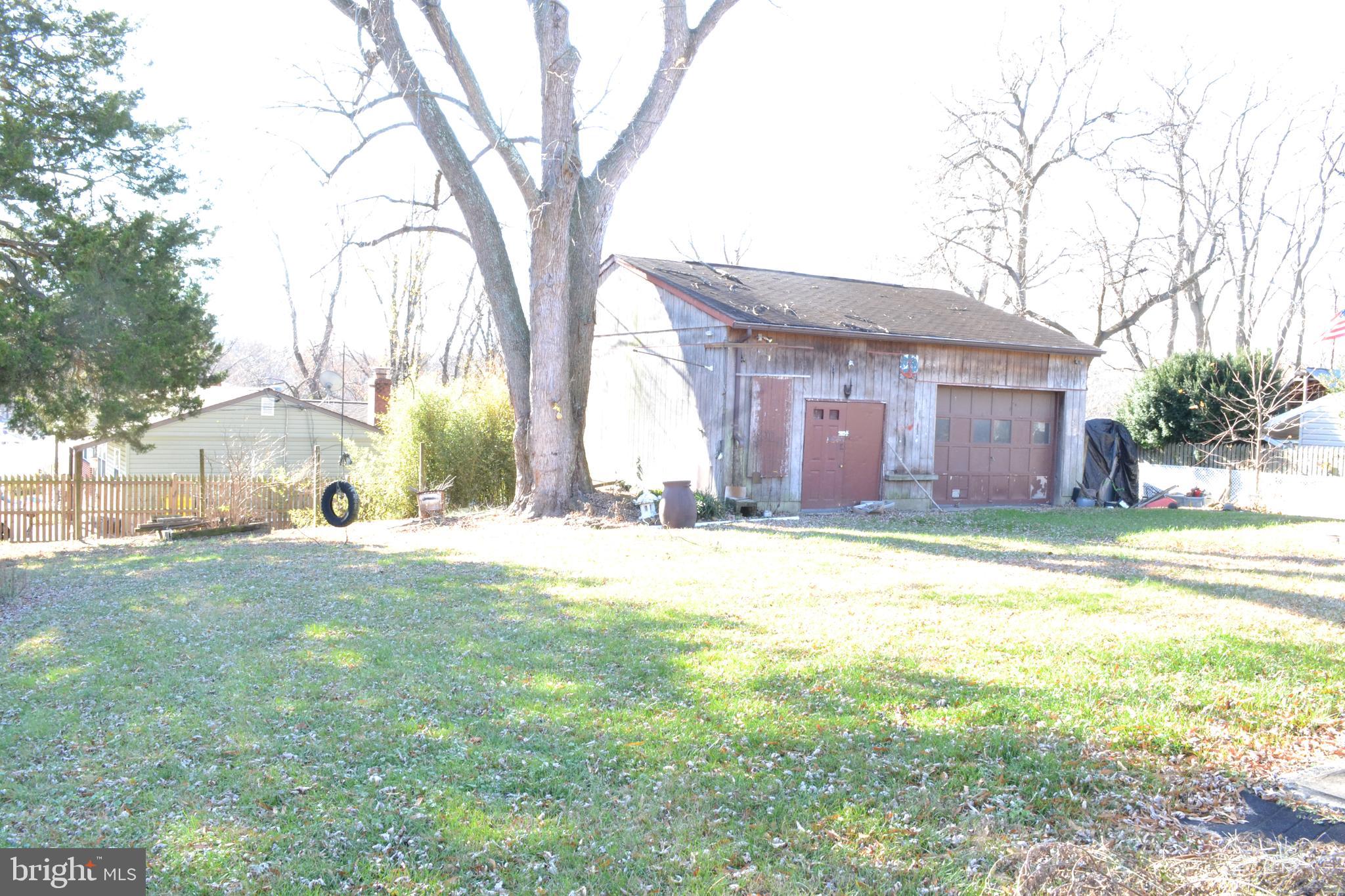 1241 Duke Lane Odenton, MD 21113 - Photo 6 of 26 a view of a house with a yard and large trees