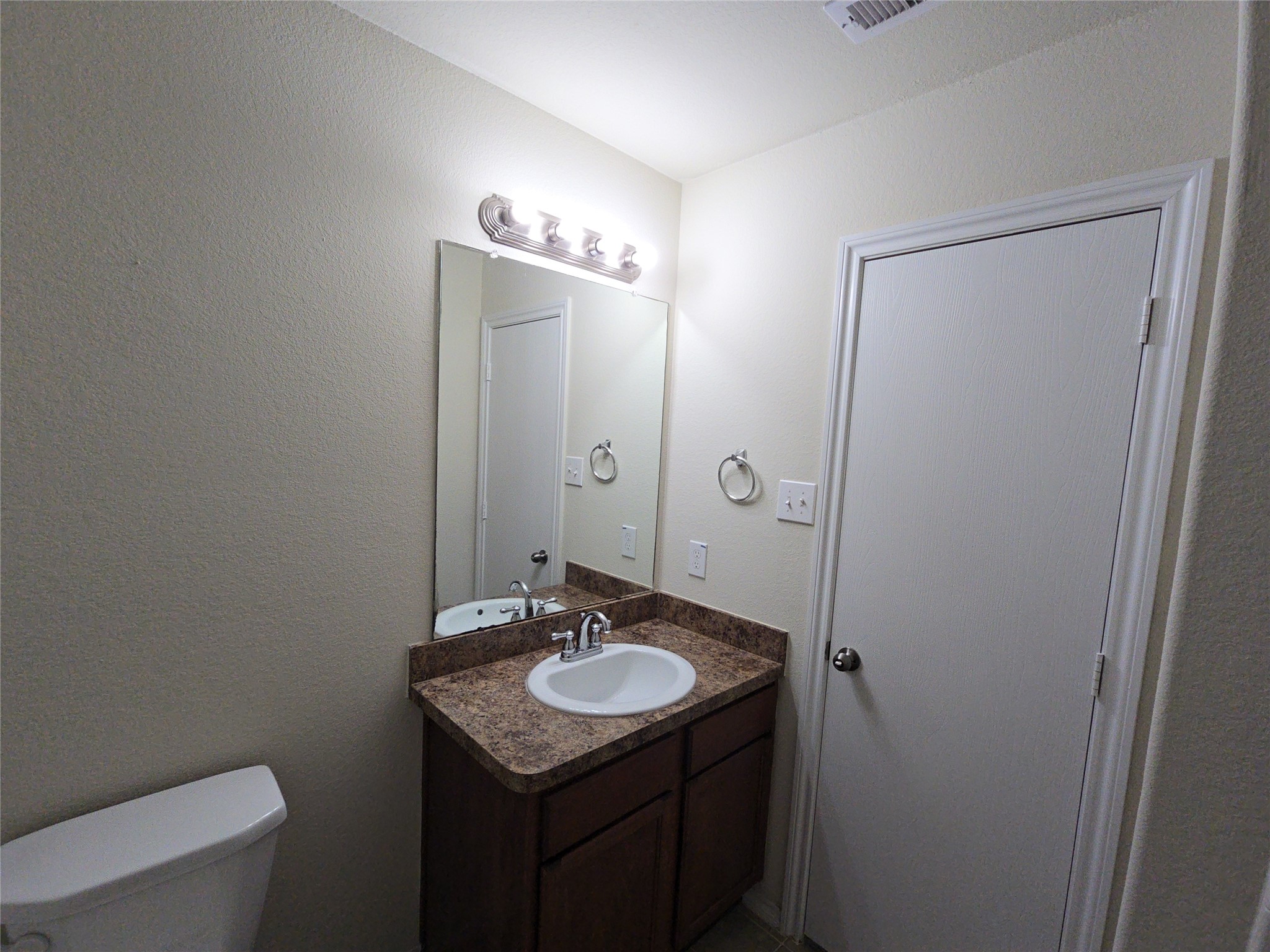 810 Lightningbug Lane Conroe, TX 77301 - Photo 16 of 27 a bathroom with a sink and a mirror
