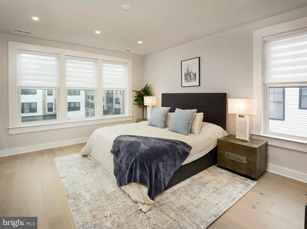 a spacious bedroom with a large bed and a large window