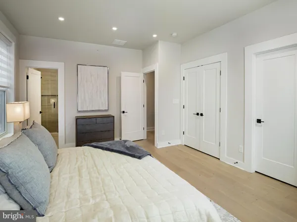 a bedroom with a large bed and chandelier