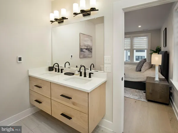 a en suite bathroom with a double vanity sink and a mirror