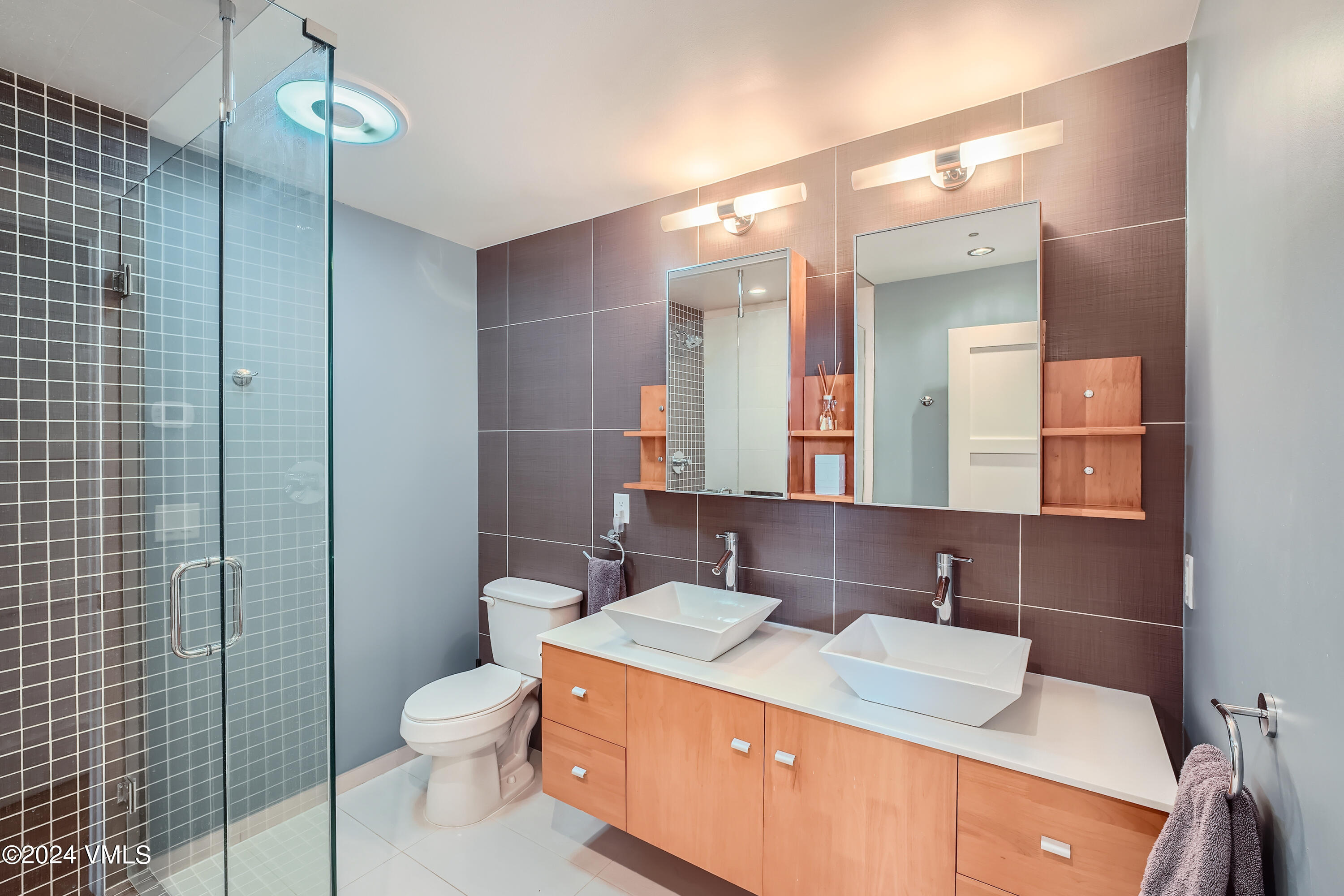 963 Lions Ridge Loop, Unit 535 Vail, CO 81657 - Photo 13 of 26 a bathroom with a sink toilet vanity and shower