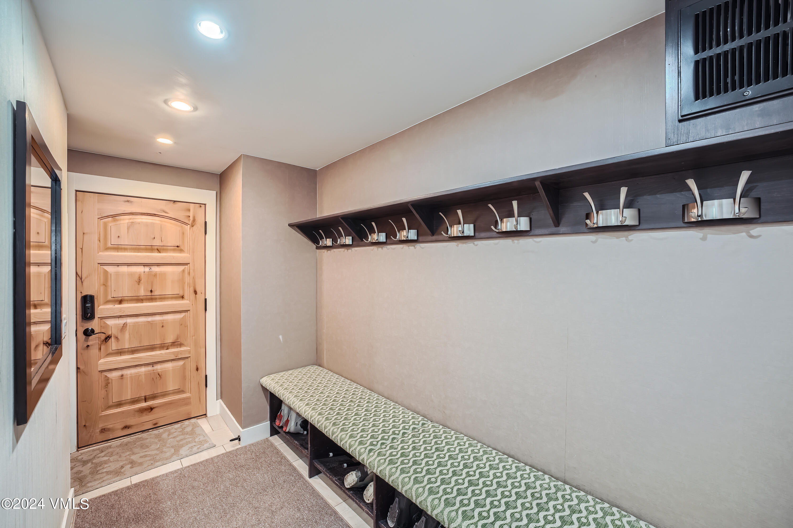 963 Lions Ridge Loop, Unit 535 Vail, CO 81657 - Photo 19 of 26 a hallway with white cabinets and wooden floor
