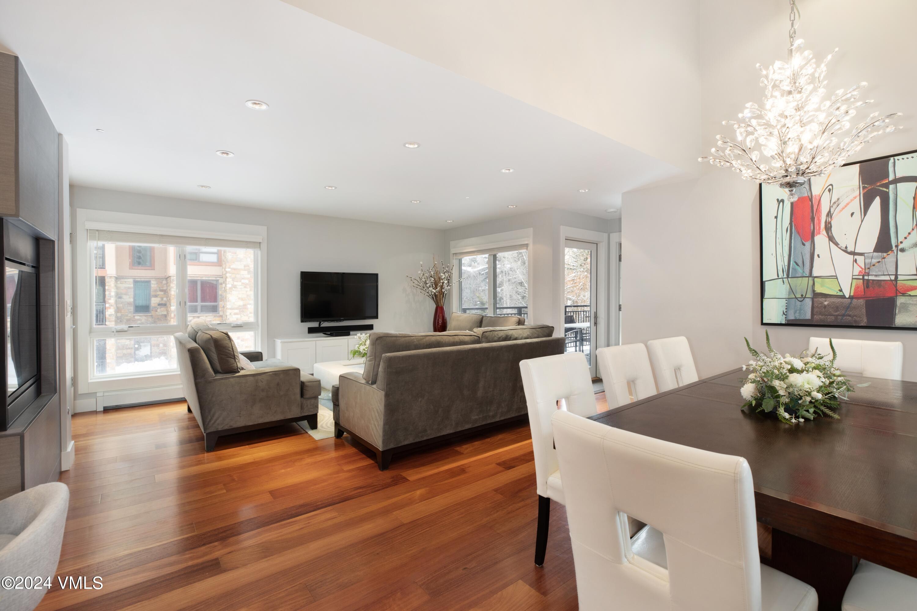963 Lions Ridge Loop, Unit 535 Vail, CO 81657 - Photo 2 of 26 a living room with furniture or chandelier and a wooden floor