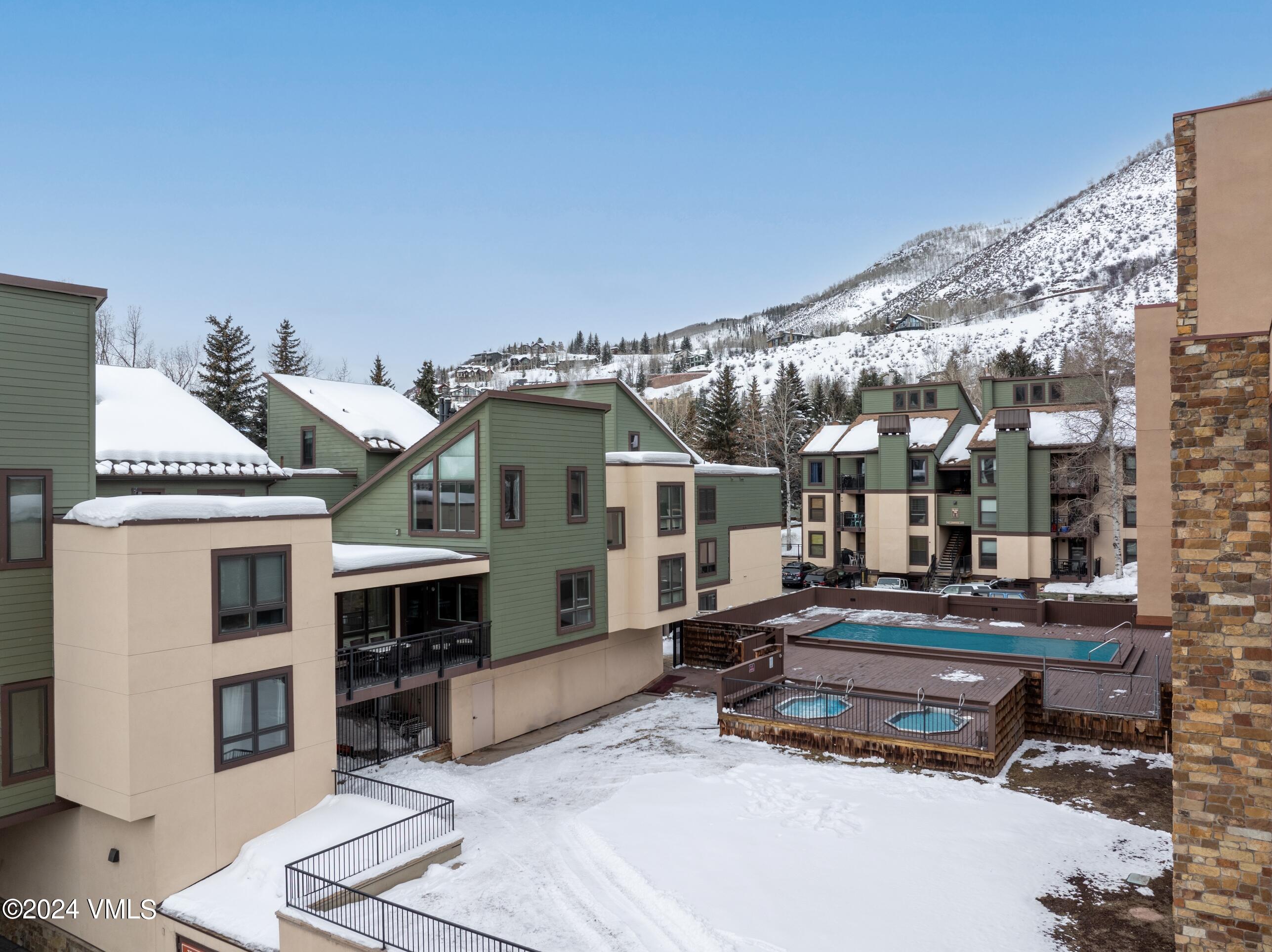 963 Lions Ridge Loop, Unit 535 Vail, CO 81657 - Photo 22 of 26 a building outdoor space with patio furniture and a potted plant