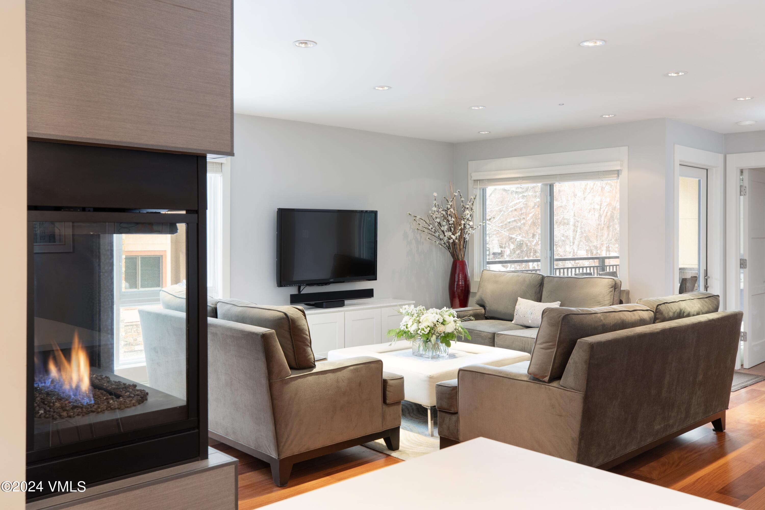 963 Lions Ridge Loop, Unit 535 Vail, CO 81657 - Photo 26 of 26 a living room with furniture and a flat screen tv