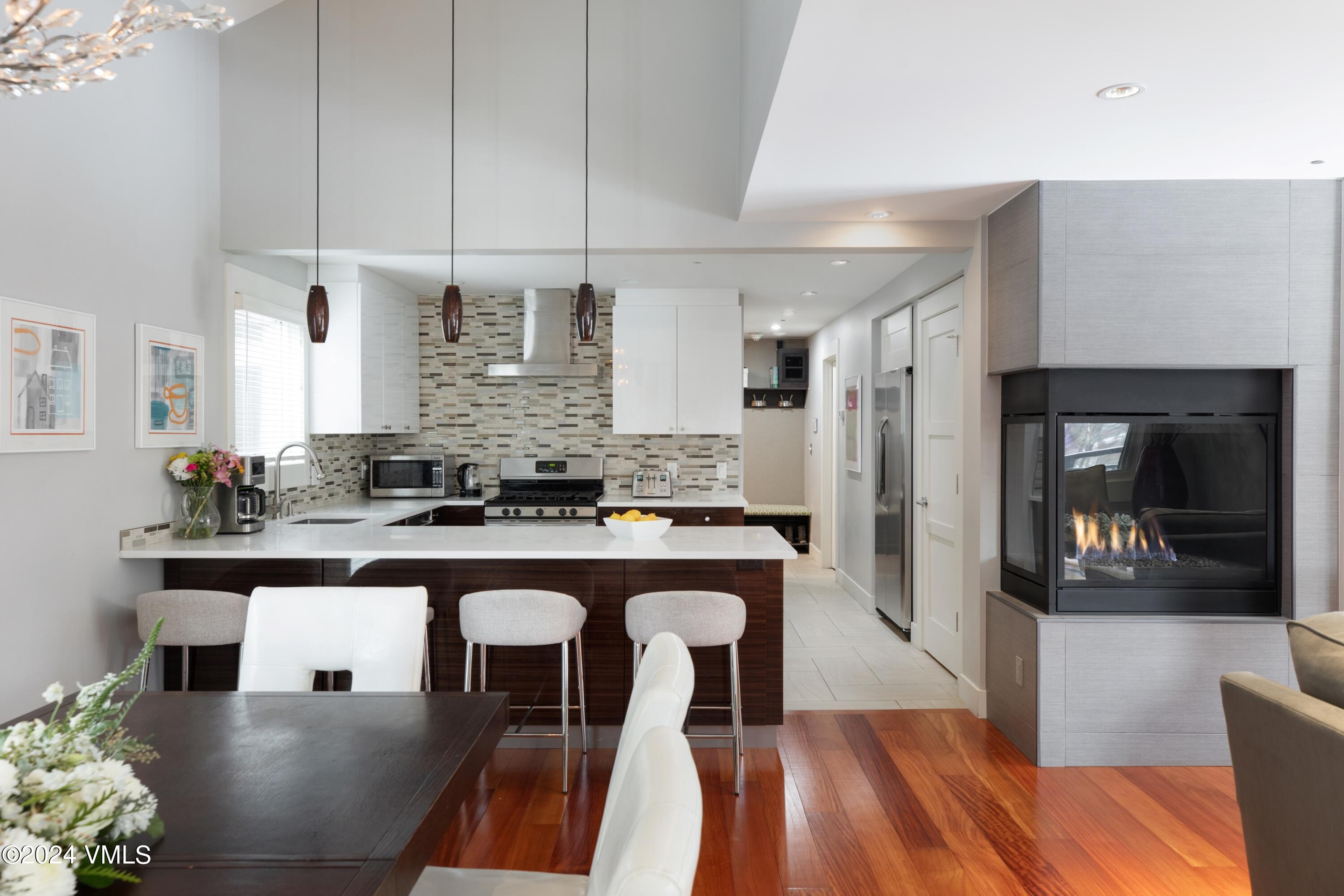 963 Lions Ridge Loop, Unit 535 Vail, CO 81657 - Photo 4 of 26 a kitchen with stainless steel appliances granite countertop a sink and a refrigerator