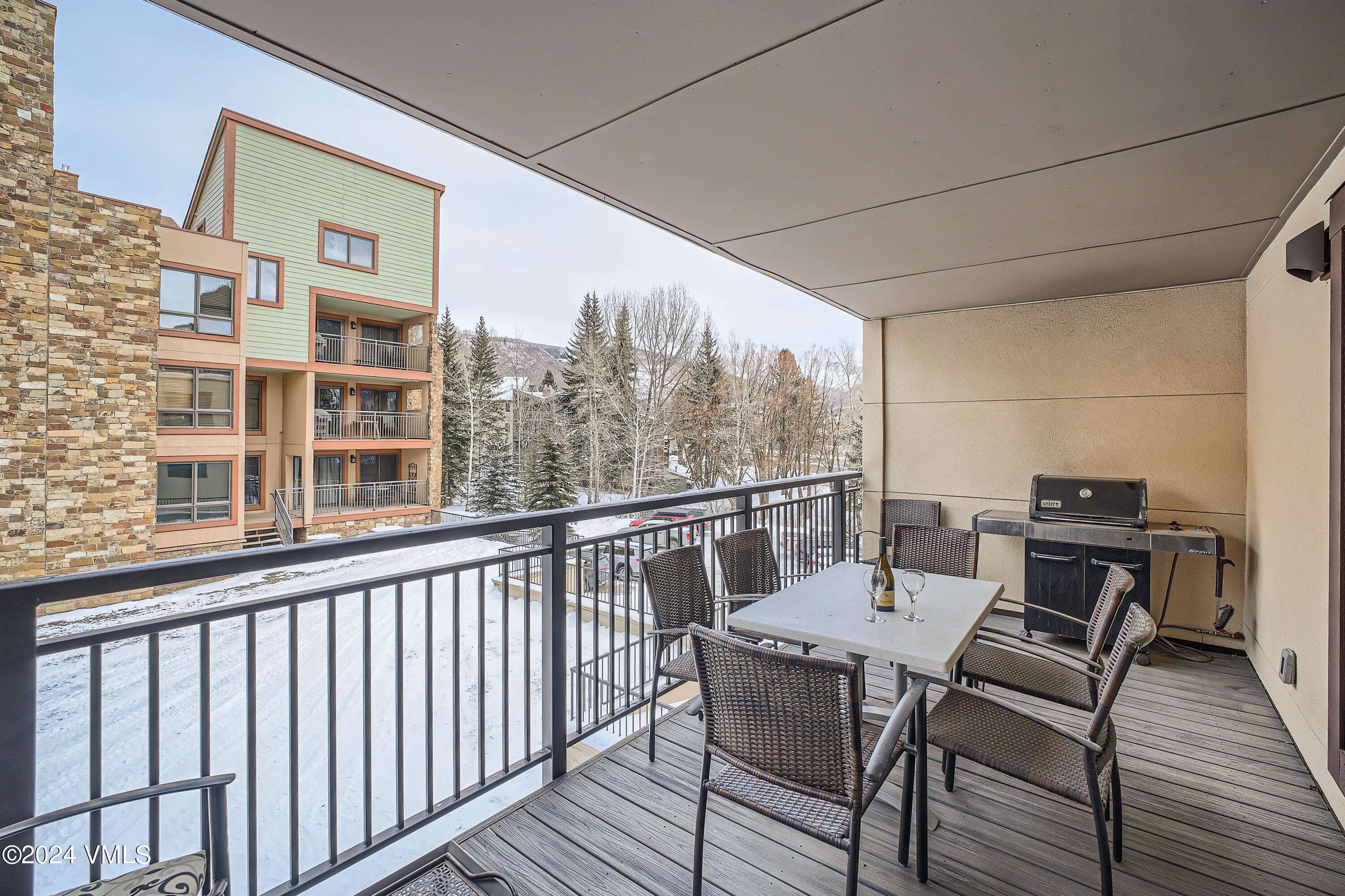 963 Lions Ridge Loop, Unit 535 Vail, CO 81657 - Photo 6 of 26 a view of a balcony with furniture and wooden floor