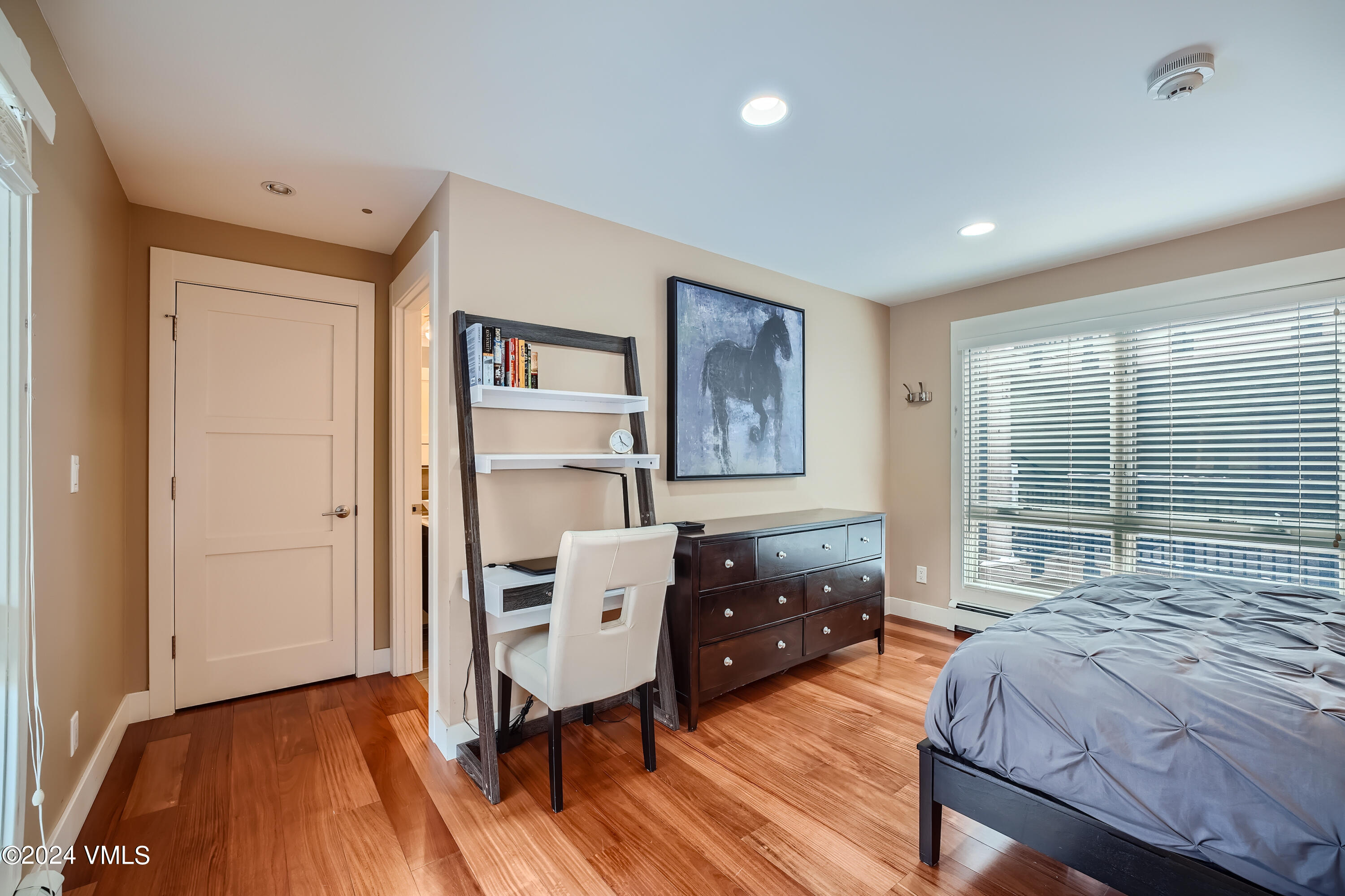 963 Lions Ridge Loop, Unit 535 Vail, CO 81657 - Photo 8 of 26 a bedroom with a bed and wooden floor