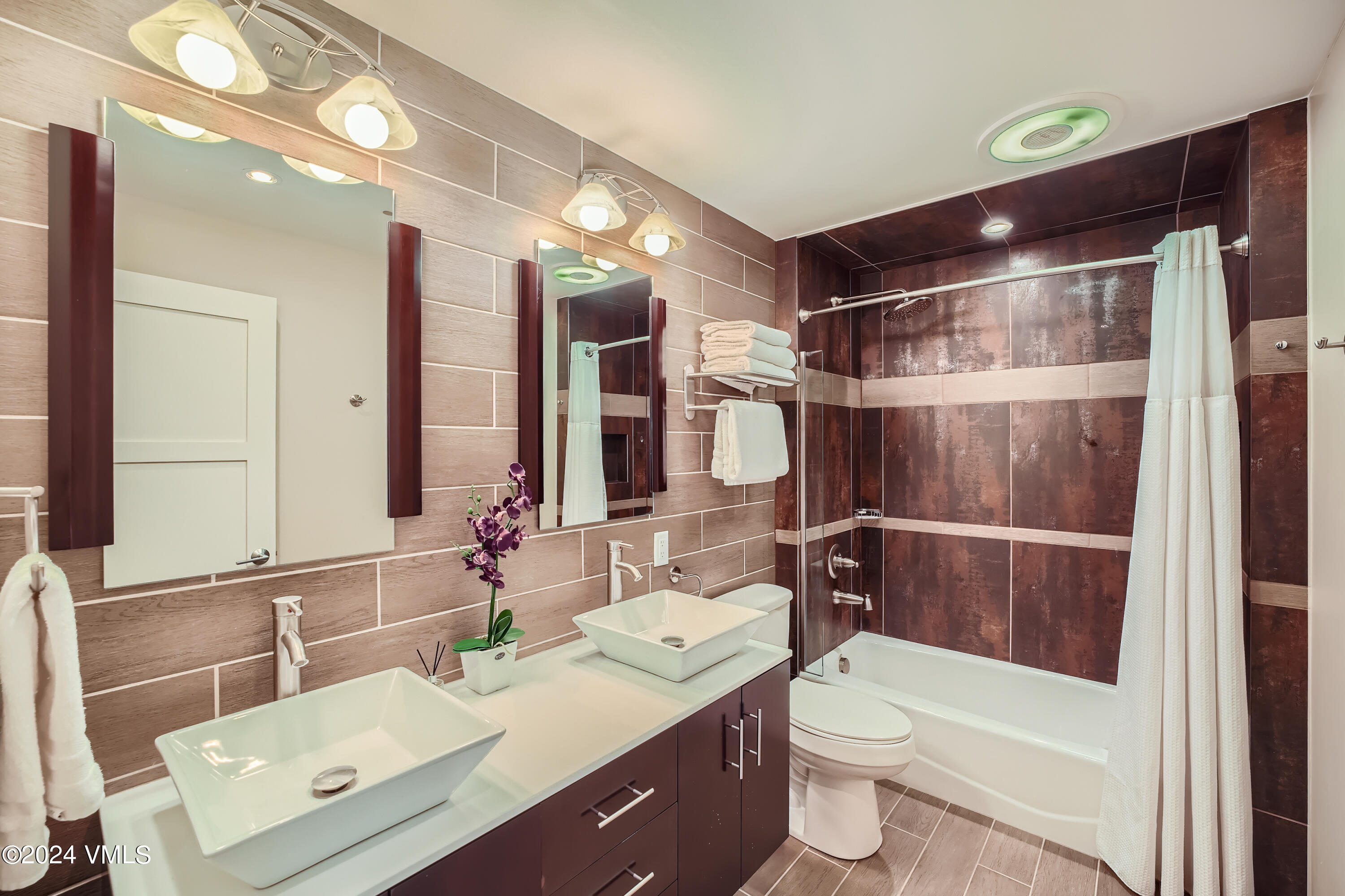963 Lions Ridge Loop, Unit 535 Vail, CO 81657 - Photo 9 of 26 a bathroom with a double vanity sink toilet and shower