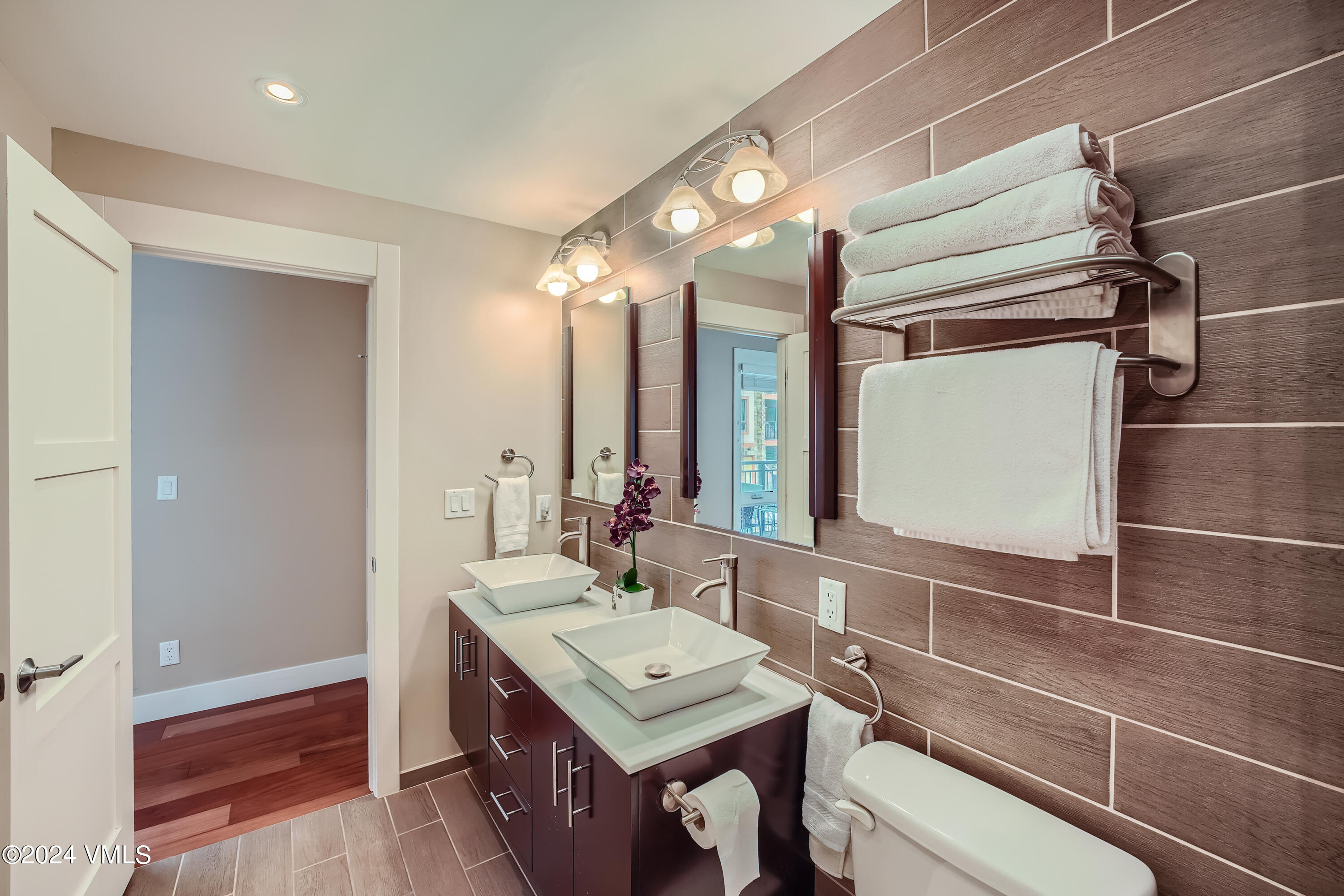 963 Lions Ridge Loop, Unit 535 Vail, CO 81657 - Photo 10 of 26 a bathroom with a sink vanity granite and shower