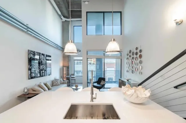 a living room with furniture and a chandelier