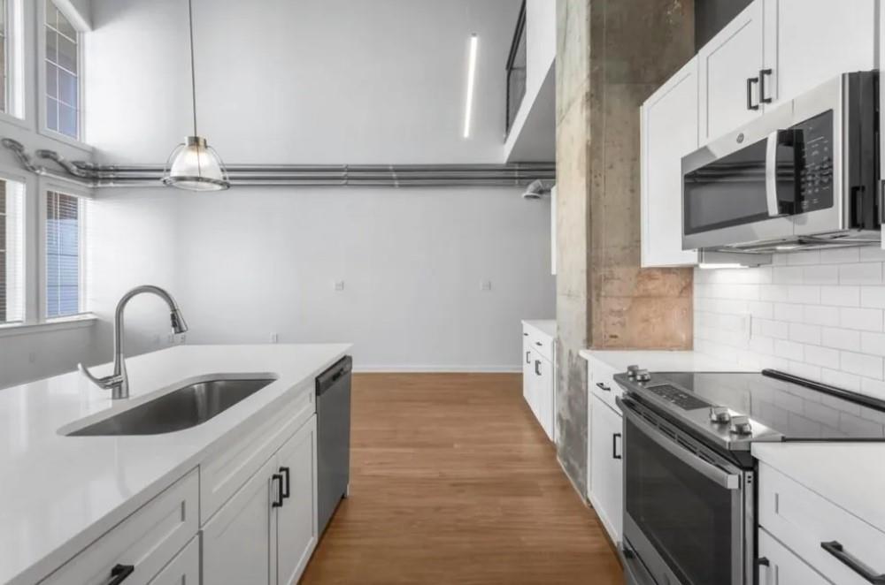 230 18th Street Northwest, Unit 11325 Atlanta, GA 30363 - Photo 24 of 43 a kitchen with stainless steel appliances granite countertop a sink and a stove
