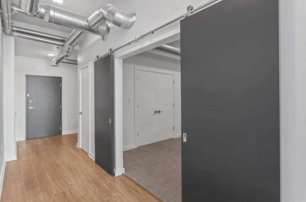 230 18th Street Northwest, Unit 11325 Atlanta, GA 30363 - Photo 34 of 43 a view of a hallway with wooden floor and a ceiling fan