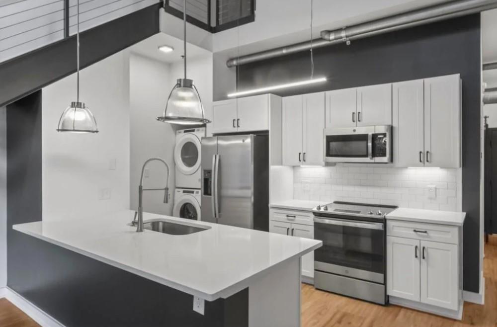 230 18th Street Northwest, Unit 11325 Atlanta, GA 30363 - Photo 40 of 43 a kitchen with stainless steel appliances a sink and stove top oven