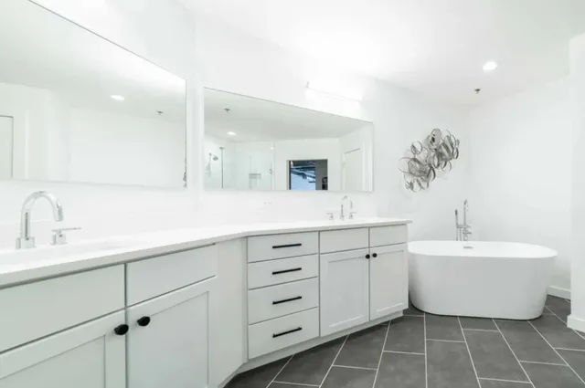 a spacious bathroom with a double vanity sink mirror and