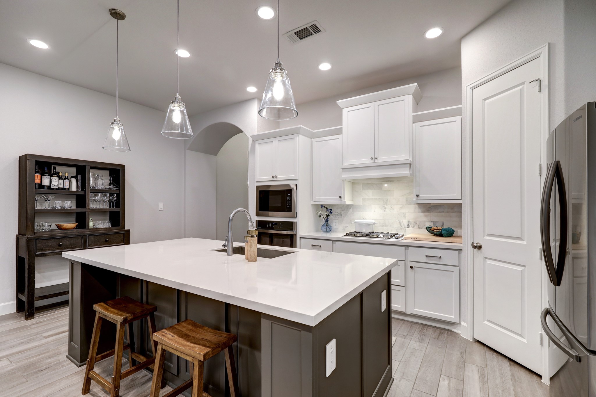 804 Fall Rock Branch Drive Conroe, TX 77304 - Photo 11 of 44 a kitchen that has a lot of cabinets a sink and wooden floor