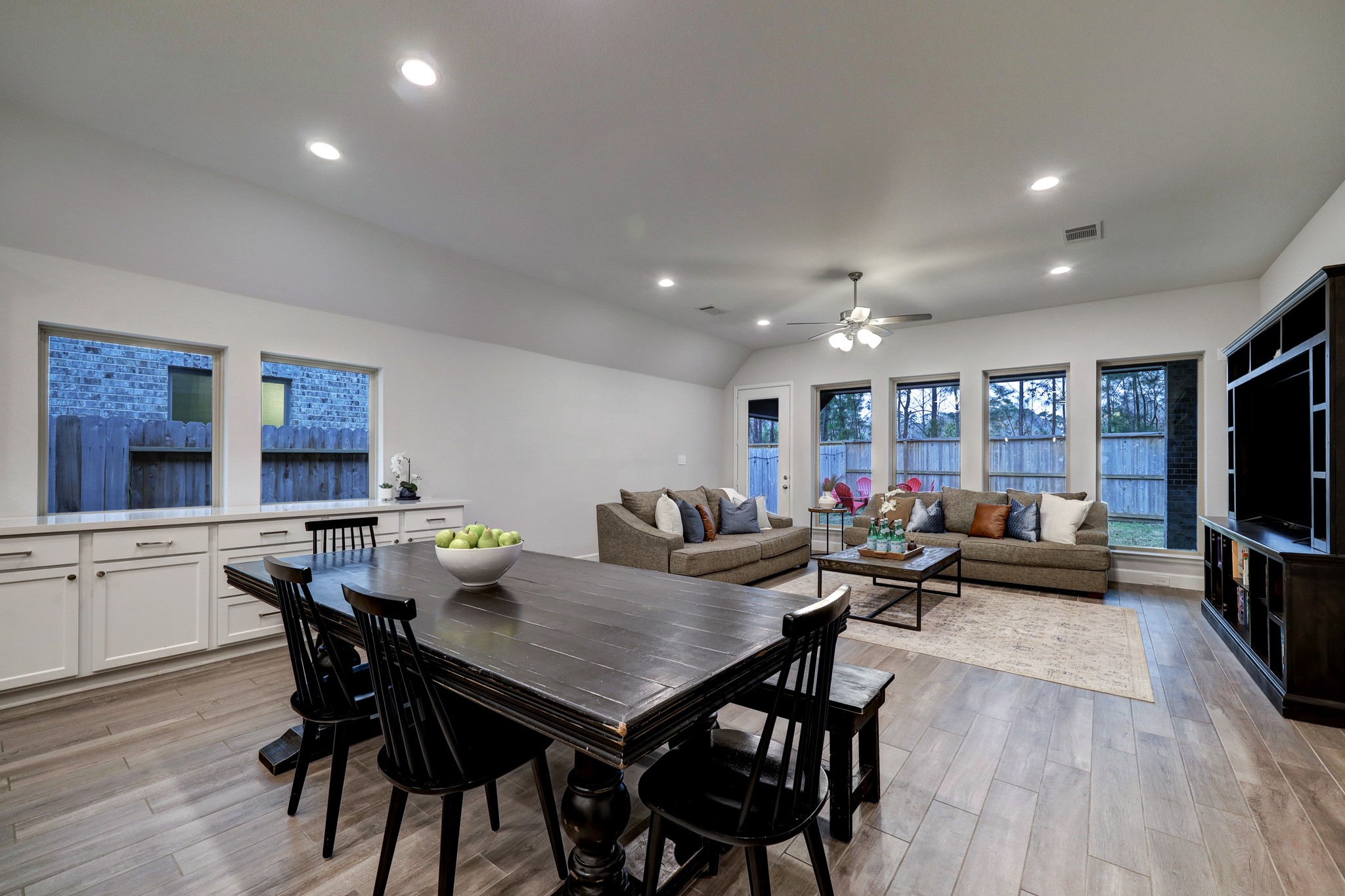 804 Fall Rock Branch Drive Conroe, TX 77304 - Photo 14 of 44 a view of a dining room with furniture wooden floor and a flat screen tv