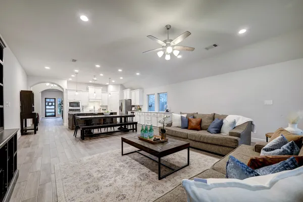 a living room with furniture and kitchen view