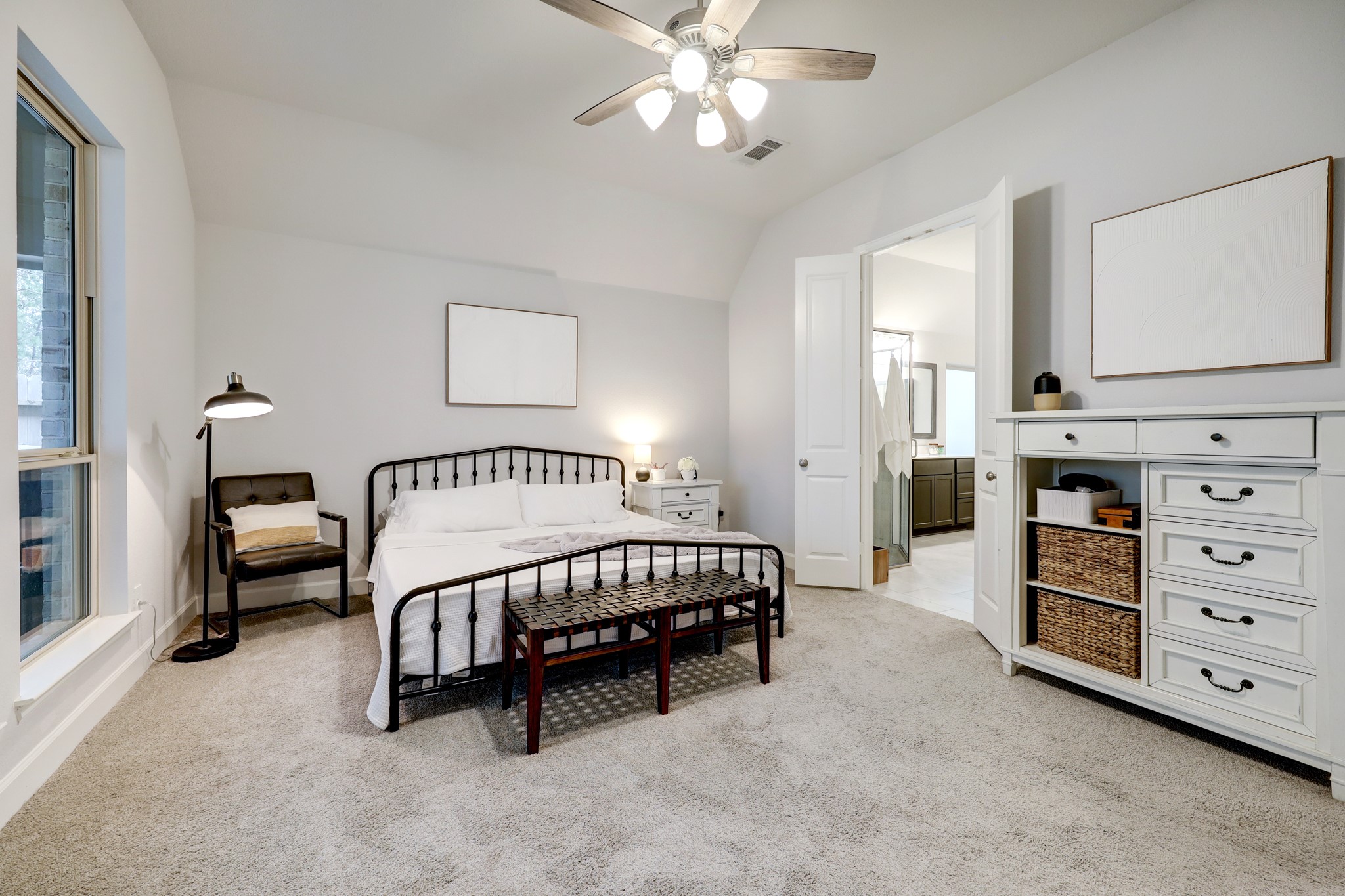804 Fall Rock Branch Drive Conroe, TX 77304 - Photo 20 of 44 a spacious bedroom with a bed a couch and dresser