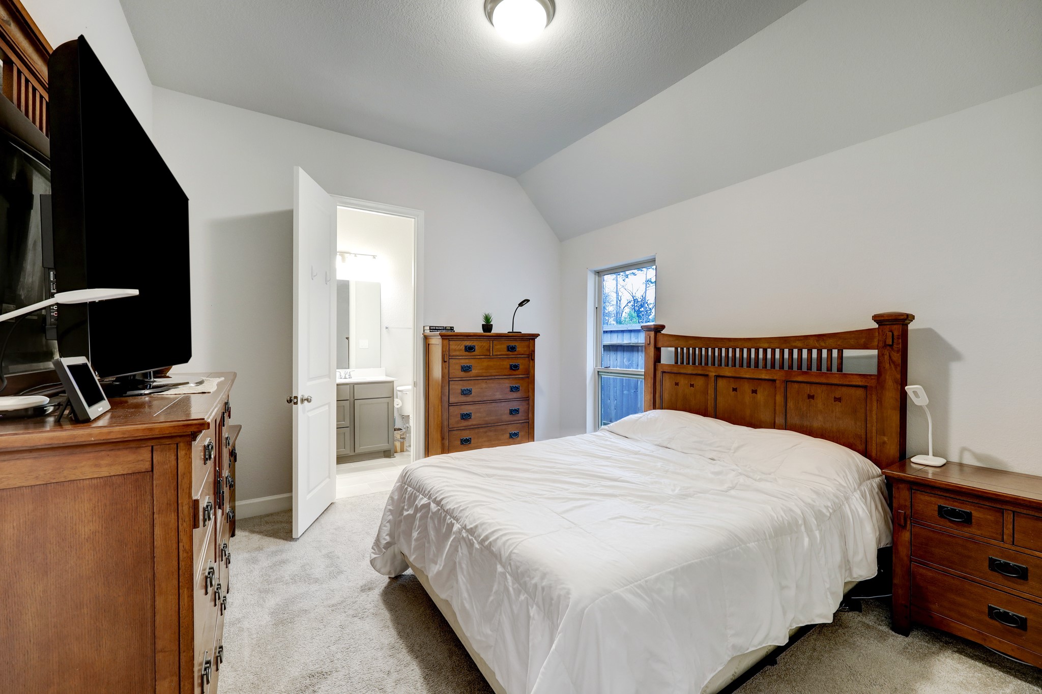 804 Fall Rock Branch Drive Conroe, TX 77304 - Photo 27 of 44 a bedroom with a bed and a television