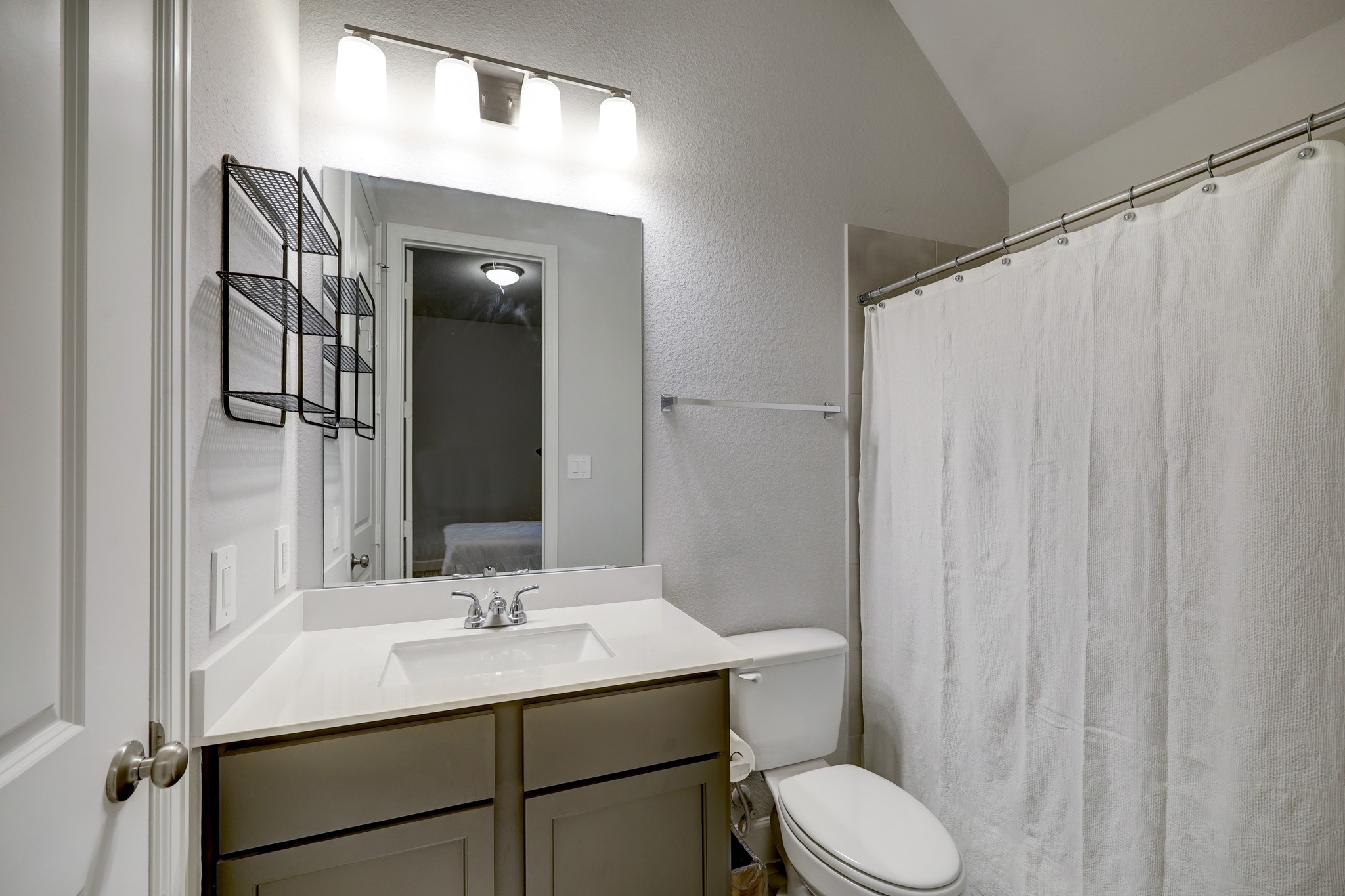 804 Fall Rock Branch Drive Conroe, TX 77304 - Photo 28 of 44 a bathroom with a sink vanity mirror and toilet