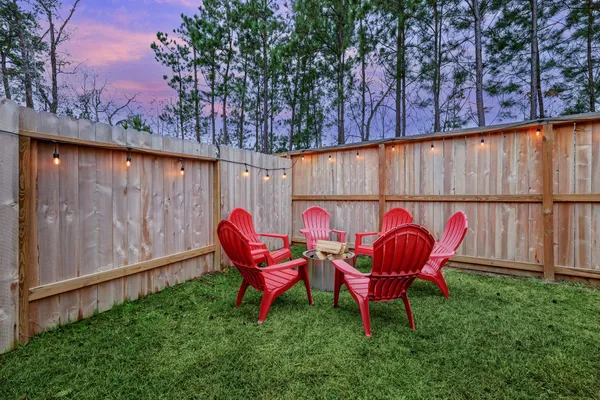 a backyard of a house with table and chairs