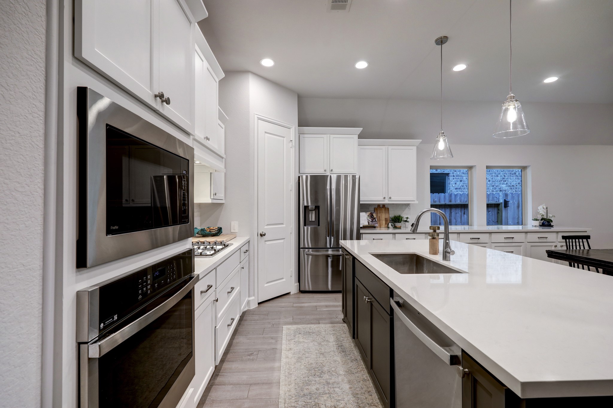 804 Fall Rock Branch Drive Conroe, TX 77304 - Photo 9 of 44 a kitchen with stainless steel appliances granite countertop a sink a stove and a refrigerator